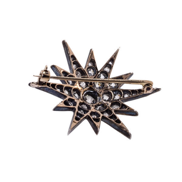 The reverse side of an antique diamond star brooch which shows the yellow gold setting