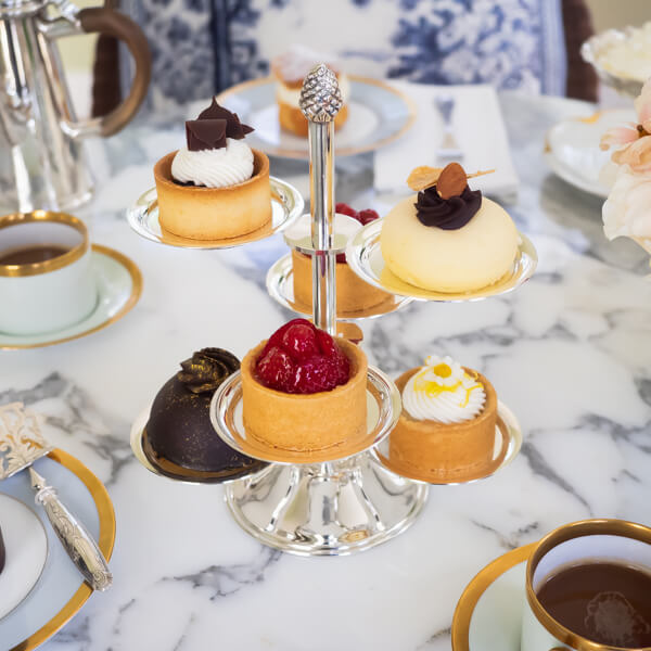 A beautifully set table featuring a silver dessert stand