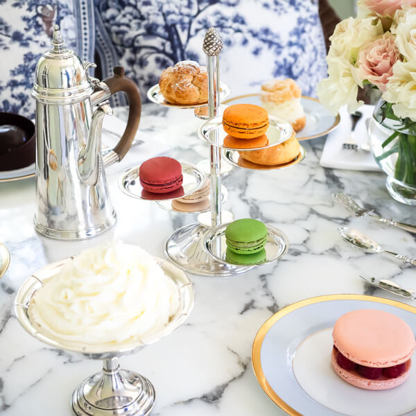 A beautiful table setting featuring a silver macaron stand
